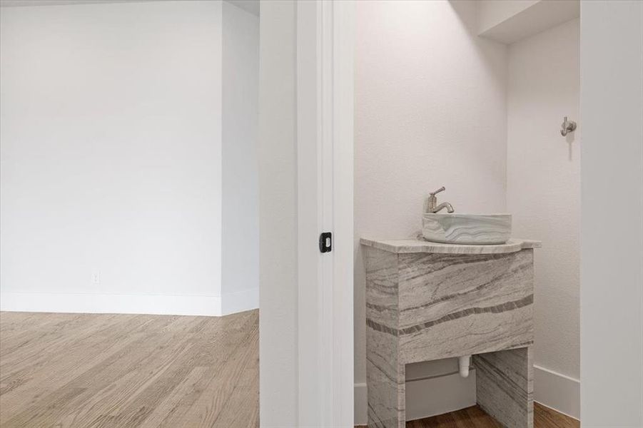 Bathroom with sink and hardwood / wood-style flooring