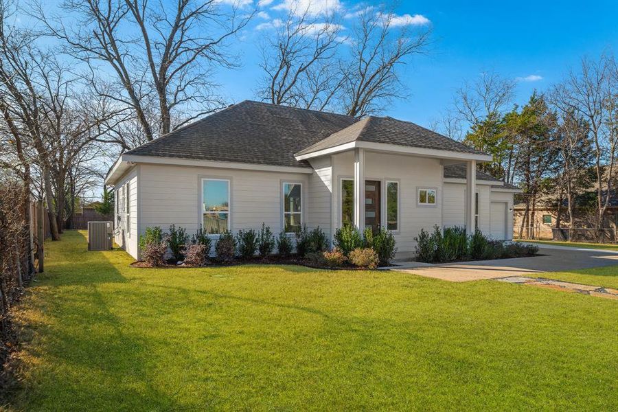 Ranch-style house with central AC unit, a garage, and a front yard