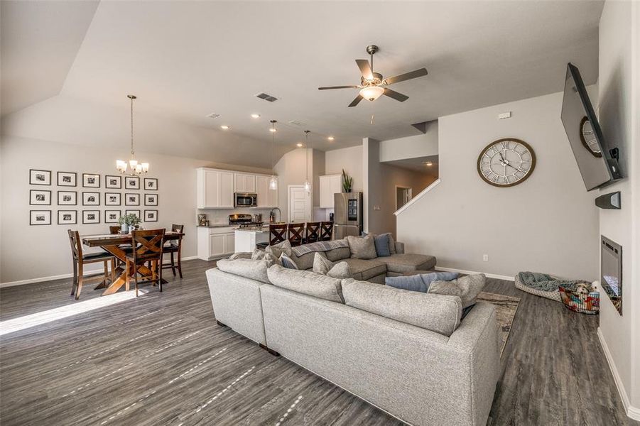 Spacious living room featuring ceiling fan and wood-style LVP flooring