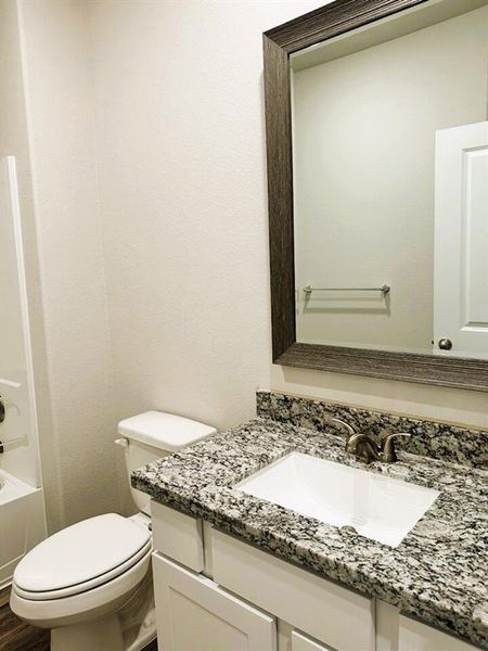 Bath 2 has linen shelves, granite counters & stylish framed mirror!