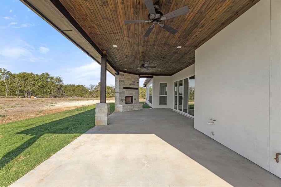 View of large patio featuring ceiling fan, water line for outside kitchen sink and gas line for gas grill