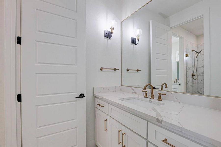 Bathroom with vanity and a tile shower