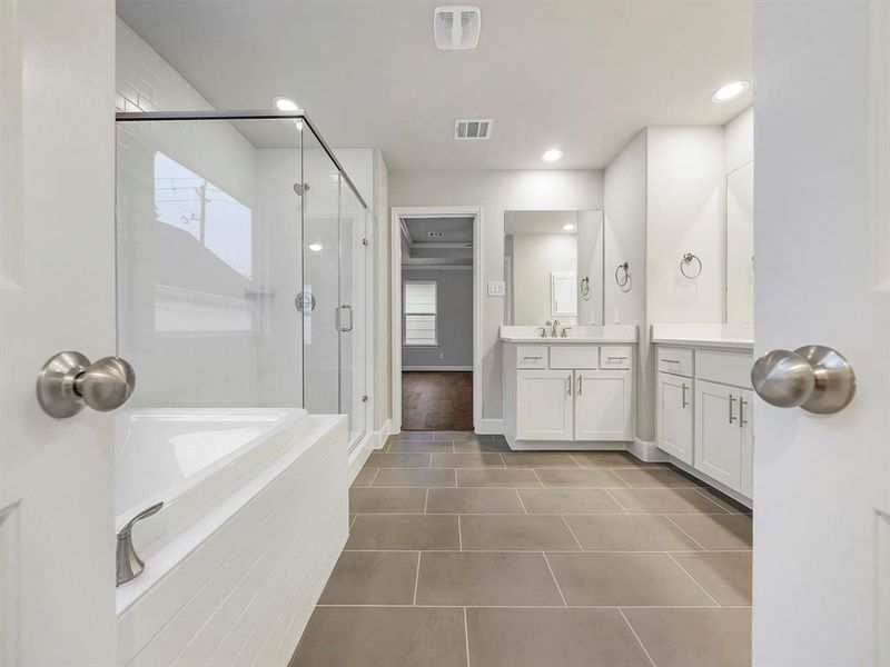 A view of the Primary Bathroom showing its dual vanities, spacious layout, custom cabinets, and quartz countertops. **1511 Auline will have a free-standing bathtub (Sample photo of a completed Sterling Floor Plan. Image may show alternative features/and or upgrades.)