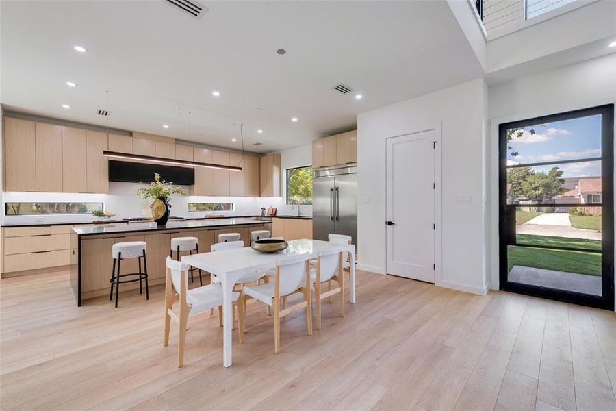 Dining space with light hardwood / wood-style floors