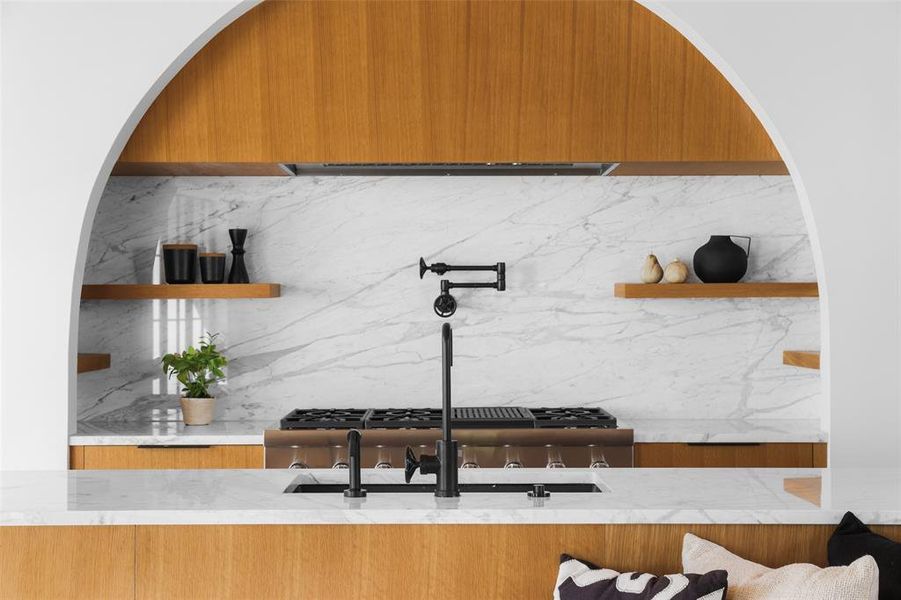 Polished soapstone adorn the kitchen counters and backsplash.