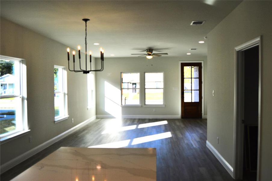 dining area with notable chandelier, a healthy amount of sunlight, and LVP flooring