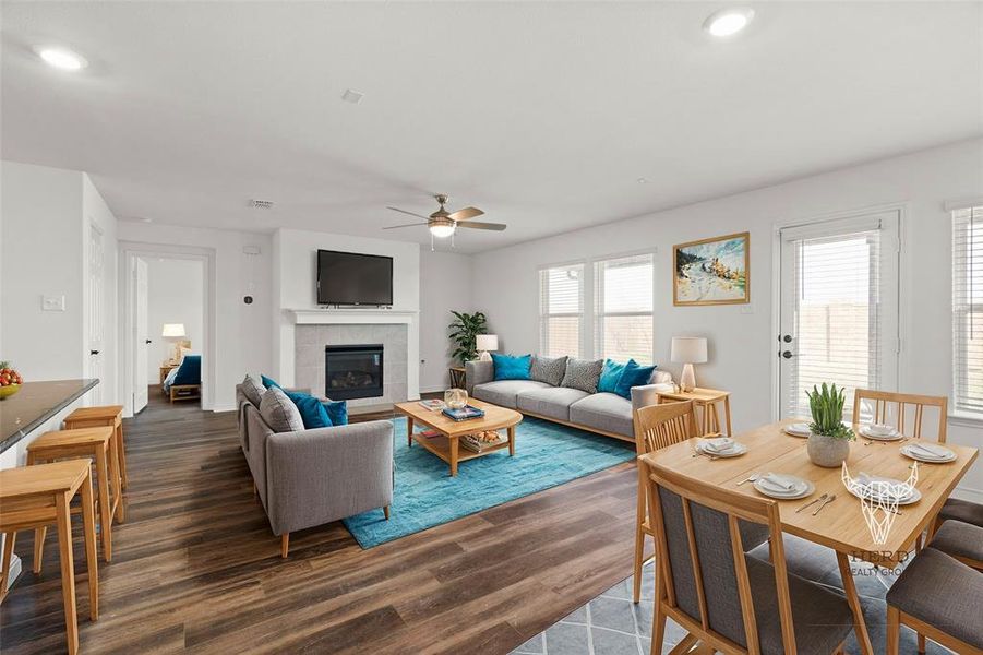 Virtually Staged Living room featuring ceiling fan, dark hardwood / wood-style floors, and a tiled fireplace