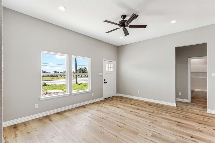 Spare room with ceiling fan and light wood-type flooring