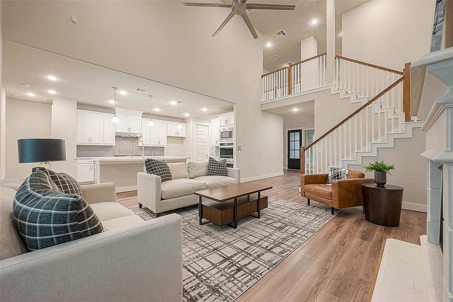 The impressive, two-story family room includes a view of the staircase that leads to a spacious game room and three bedrooms all with walk-in closets.