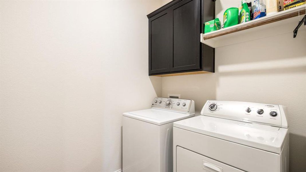 Laundry area with cabinets and washing machine and clothes dryer