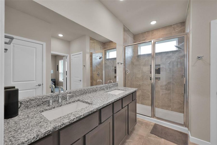 Your primary bathroom comes complete with a double vanity that provides plenty of storage space underneath. Your oversized walk-in shower is perfect for nice rinse after a long day.