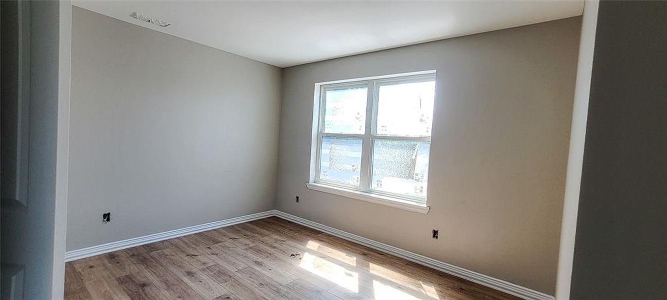 Spare room with light wood-type flooring