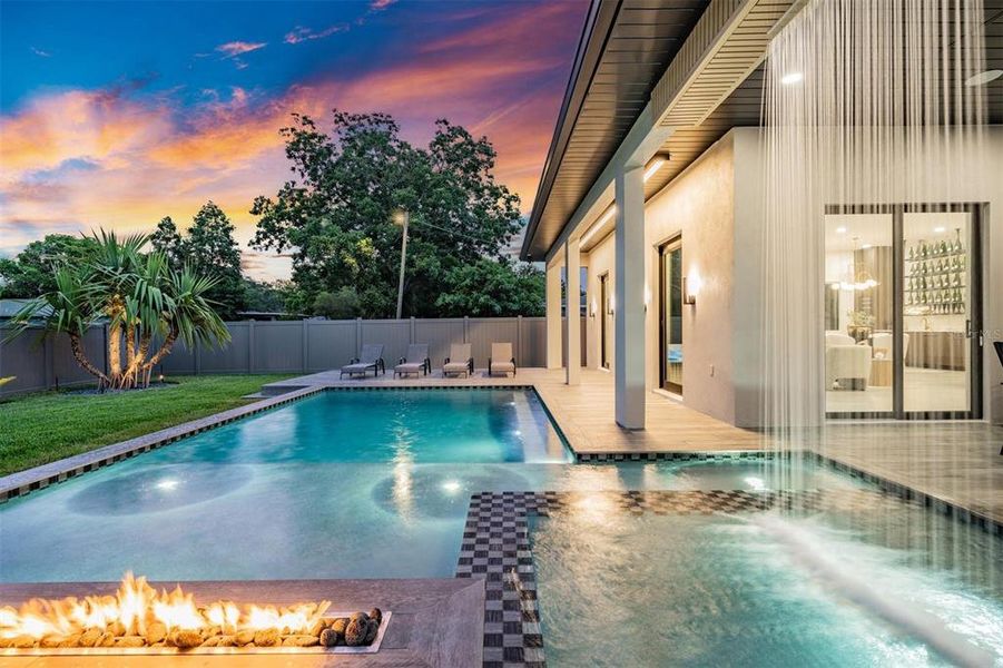 Twlight Pool With Waterfall and Linear Gas Fire Pit