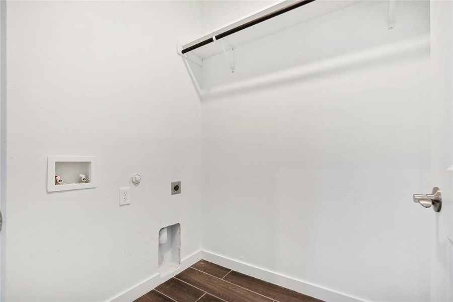 Washroom featuring washer hookup, gas dryer hookup, hookup for an electric dryer, and dark hardwood / wood-style flooring