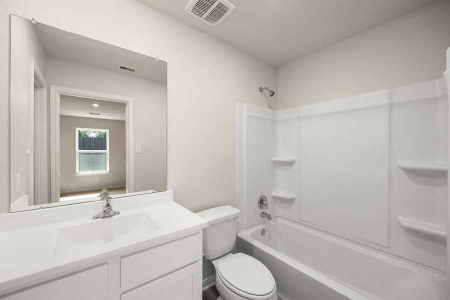 The master bathroom has a shower/tub fit for a king. It is spacious and has shelves for your shampoo bottles.