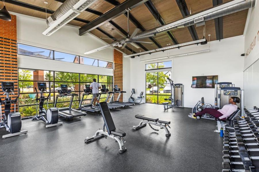 Exercise room featuring high vaulted ceiling and wood ceiling