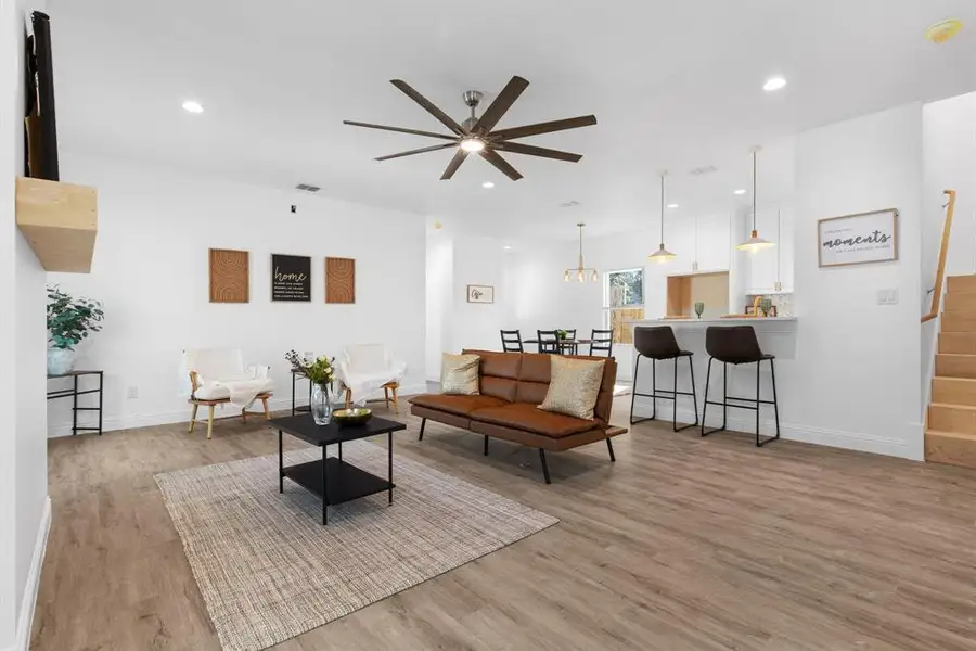 Living room featuring ceiling fan and light hardwood / wood-style floors