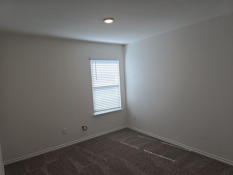 Unfurnished room with dark colored carpet