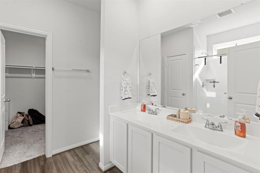 Experience the convenience of a spacious en-suite with an expansive walk-in closet, designed for effortless organization and accessibility.