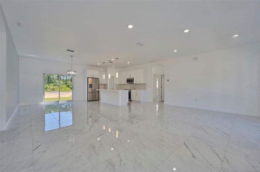 Doorway to right leads into the master bedroom suite, laundry area and garage access