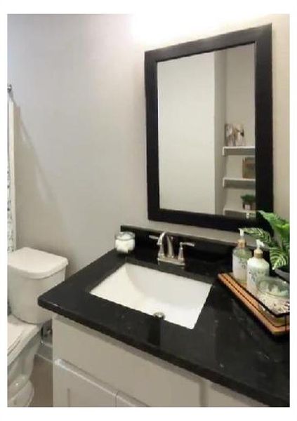 Bathroom with vanity and toilet