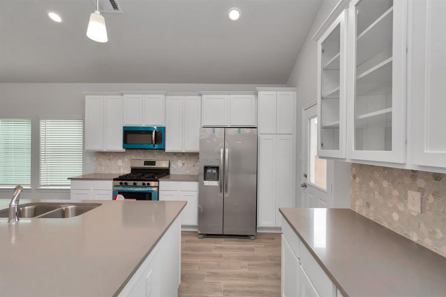 This kitchen is a chef's dream, featuring brand-new stainless steel appliances, Quartz countertops, and sleek white cabinetry with ample storage. The contemporary design is both functional and stylish, making meal preparation a pleasure. The open layout ensures that the kitchen seamlessly connects with the living and dining areas, perfect for entertaining guests or enjoying family meals. **This image is from another Saratoga Home - Wren floorplan.**