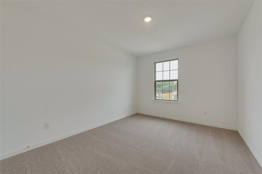 Spare room with light colored carpet