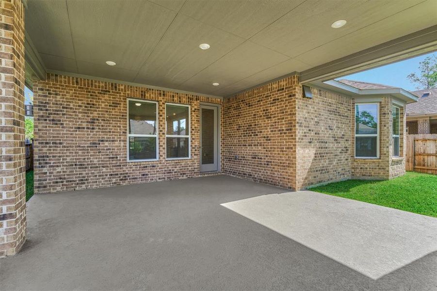 This back patio features four extra feed of covered space, perfect for lounging, entertaining, or grilling up a perfect burger!