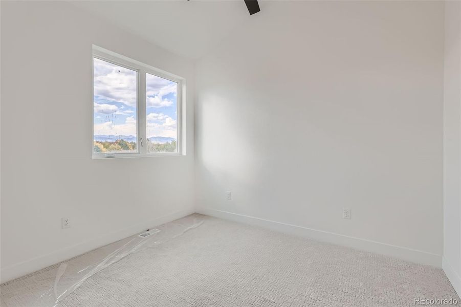 One of two extra bedrooms on 3rd level with vaulted ceilings, large closets, and ceiling fans. Great options for guest rooms or additional office space.