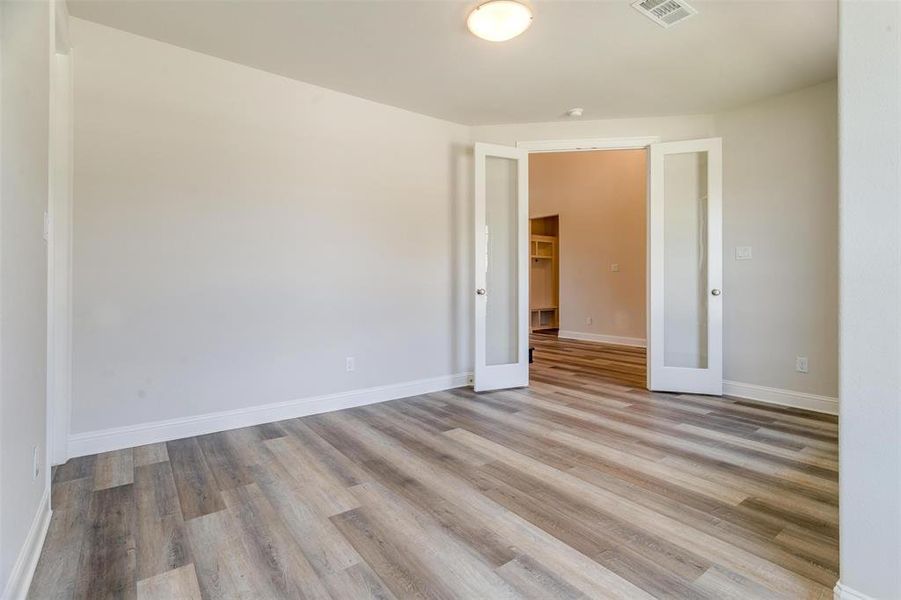 Unfurnished room featuring light wood-type flooring