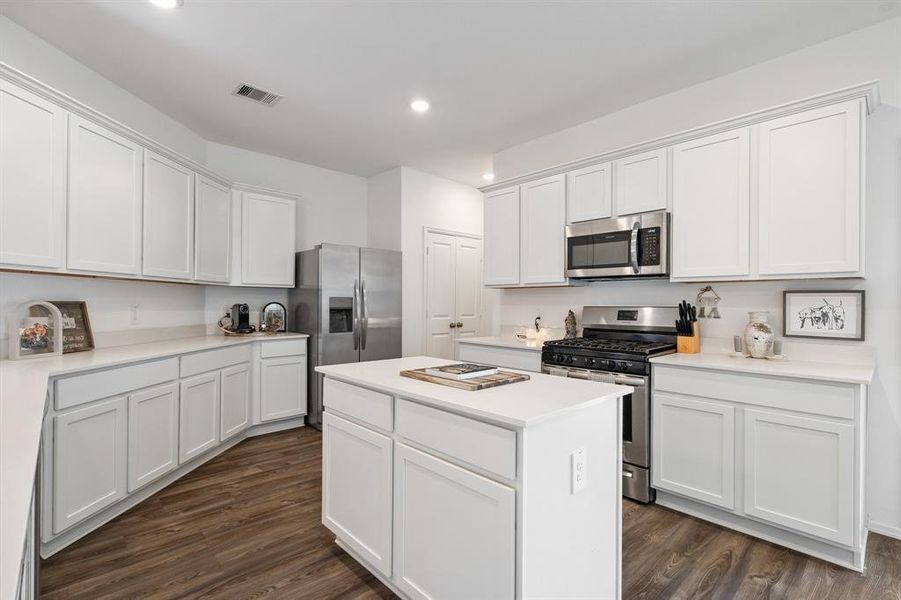 Lots of cabinets and storage space in this kitchen. Plus, you have a pantry and laundry room for additional storage space.