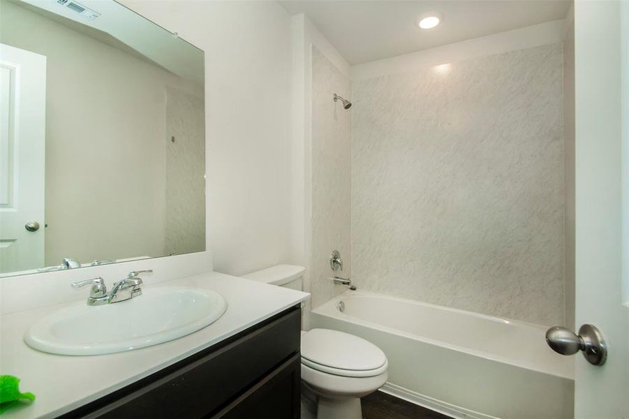 Full bathroom with shower / bathtub combination, vanity, and toilet