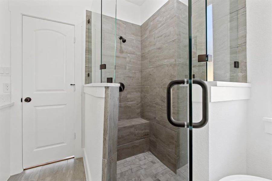 Bathroom featuring walk in shower and hardwood / wood-style flooring