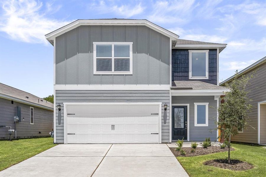 View of front facade with a garage and a front yard