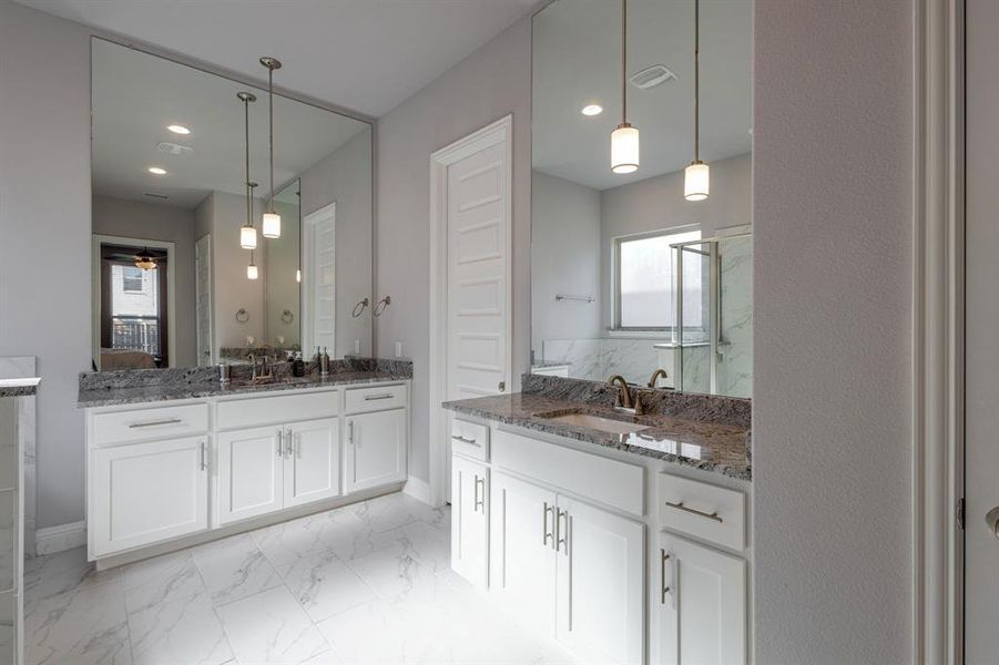 Bathroom with ceiling fan, an enclosed shower, and vanity