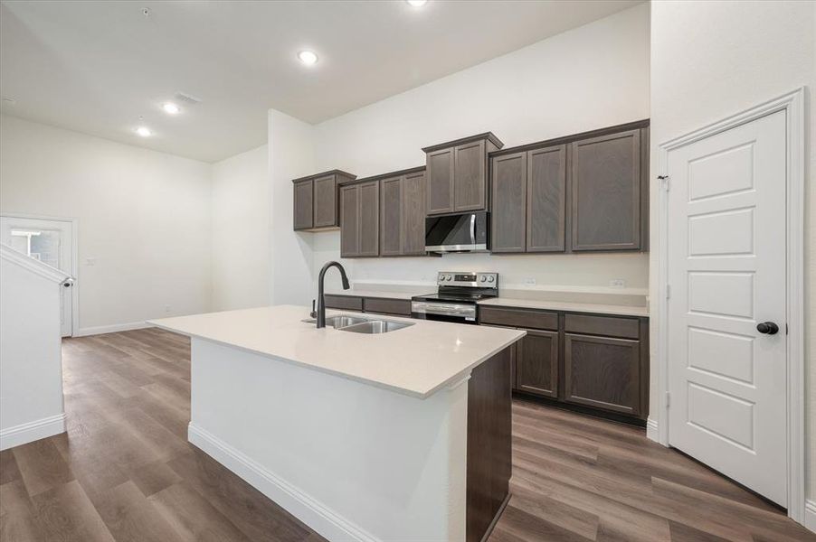 Quartz Counters, Door is to OVERSIZED BRIGHT pantry with it's own Transom Window