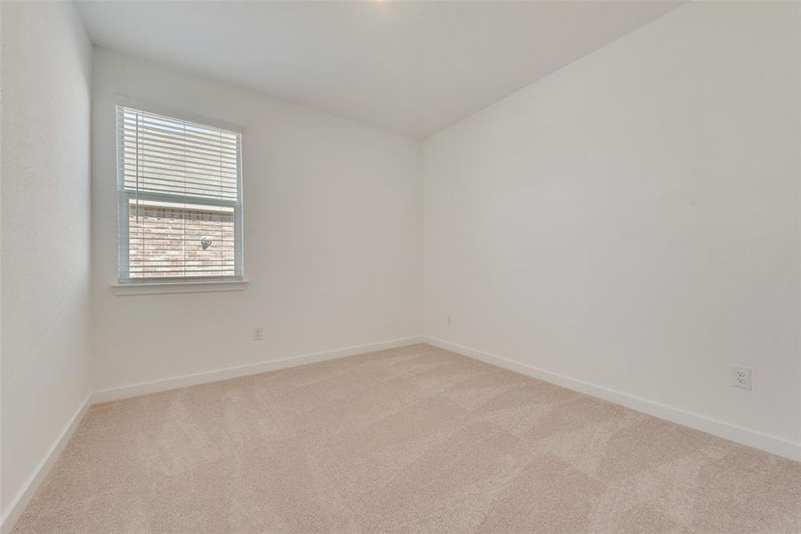 Empty room featuring light carpet