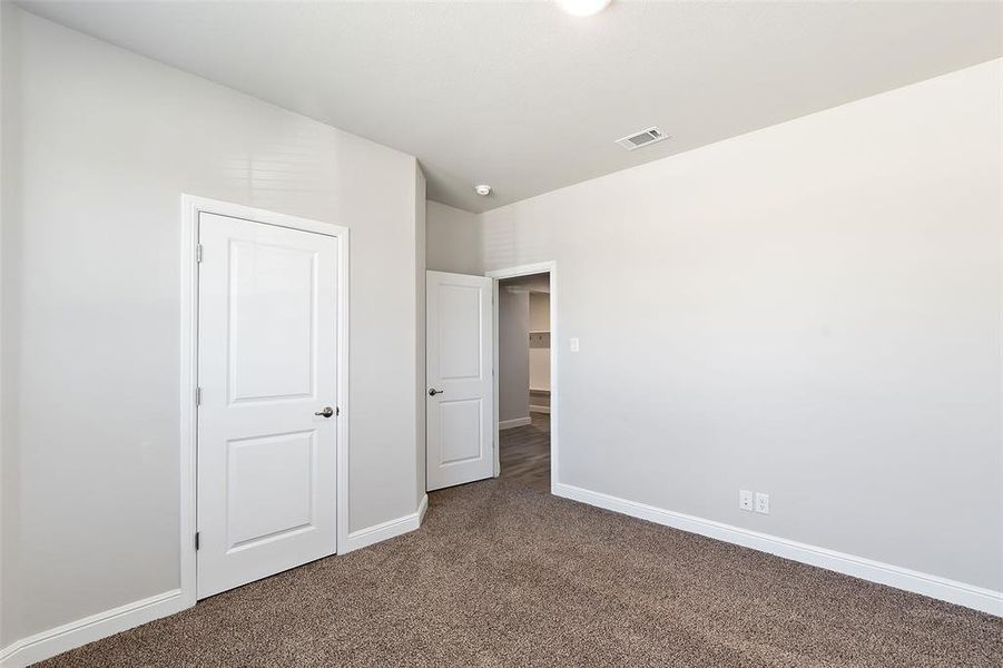 Unfurnished bedroom with carpet flooring