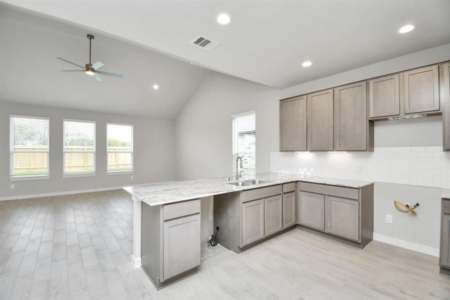 The open concept effortlessly connects the kitchen to the expansive family room, forming a perfect hub for gatherings. This seamless flow creates an inviting space where cooking and socializing come together harmoniously. Sample photo of completed home with similar floor plan. Actual colors and selections may vary.