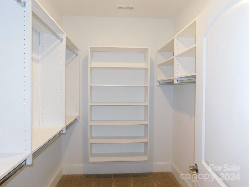 Huge walk in closet with upgraded shelving