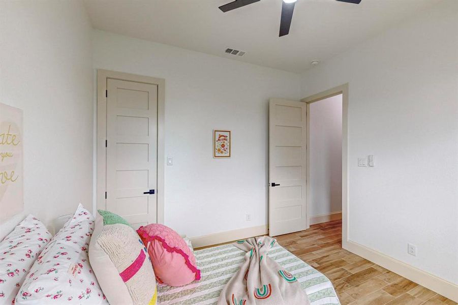 Bedroom featuring light hardwood / wood-style flooring and ceiling fan