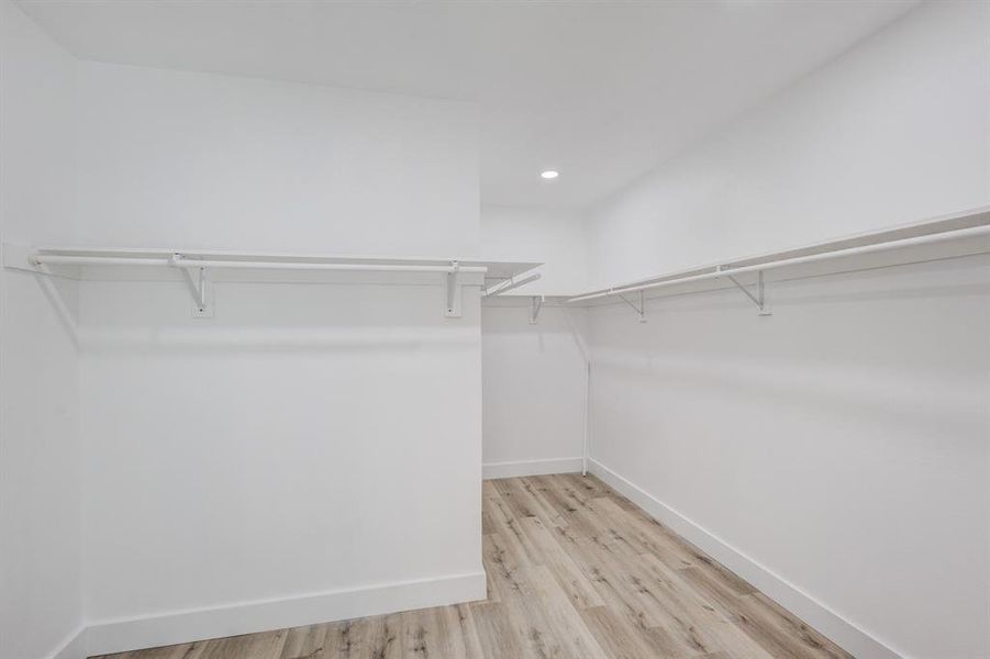 Walk in closet featuring light hardwood / wood-style flooring