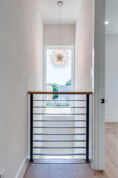 Interior details featuring a chandelier and wood-type flooring