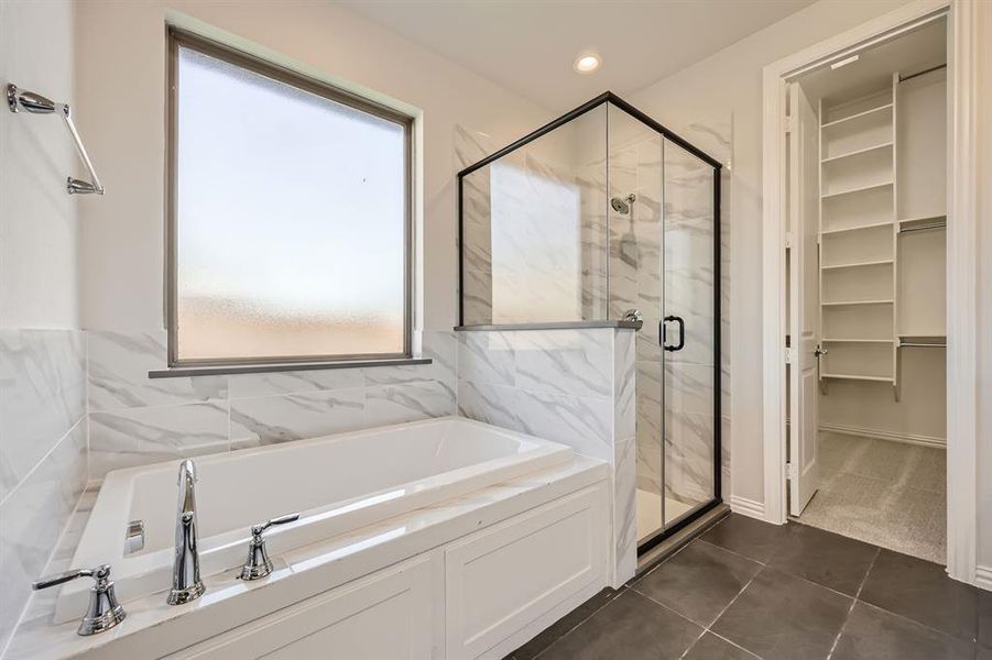 Bathroom with plus walk in shower and tile patterned flooring