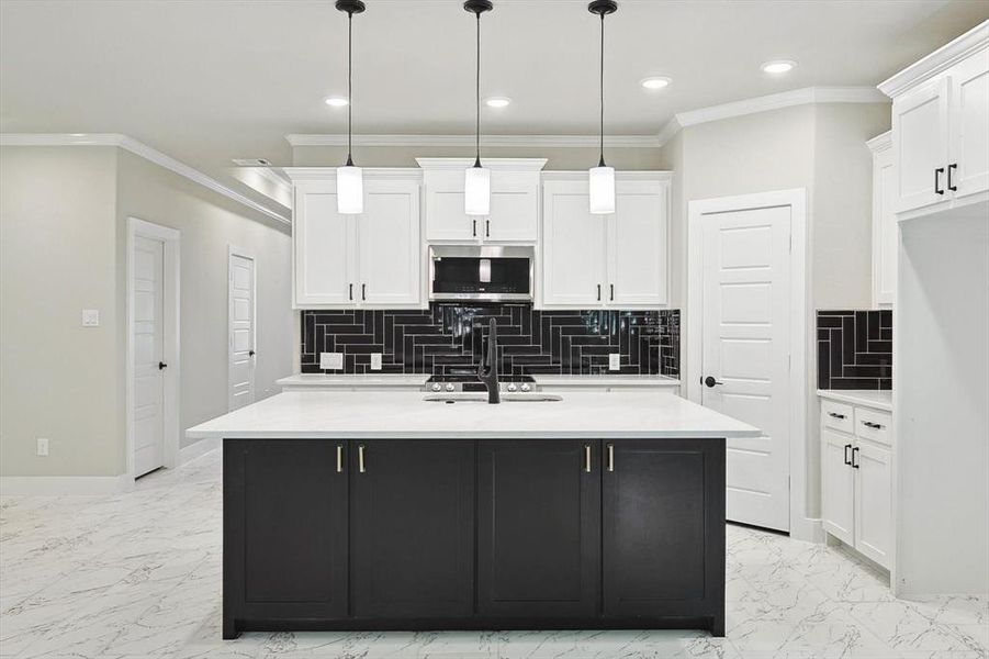 Kitchen with decorative light fixtures, white cabinetry, and light tile floors