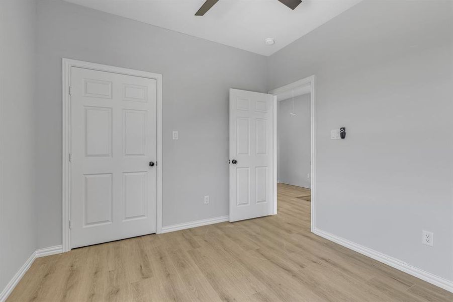 Unfurnished bedroom featuring light hardwood / wood-style flooring and ceiling fan