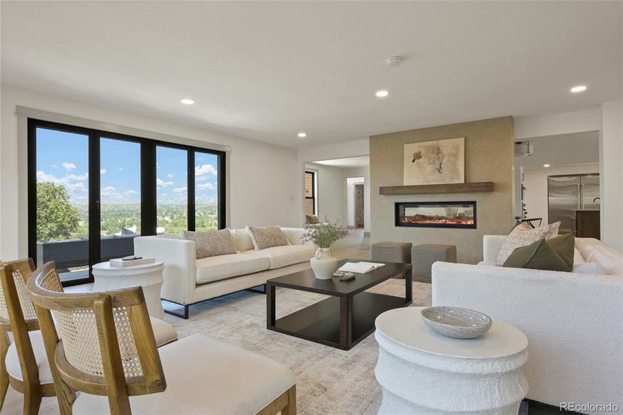 Living room with folding doors and a 50 inch see through gas fireplace