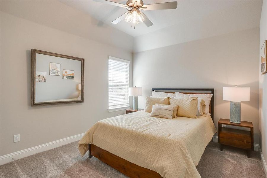 Bedroom featuring ceiling fan and carpet flooring