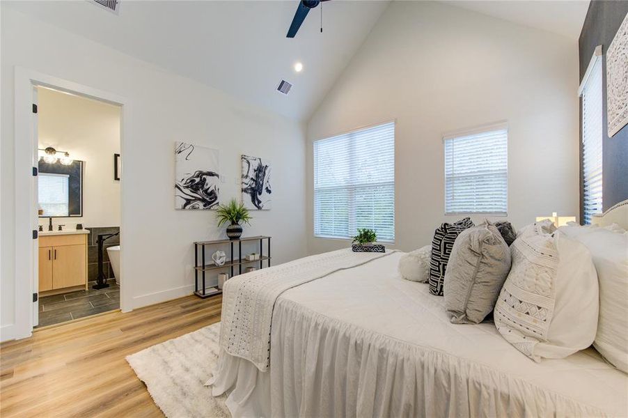 Primary Bedroom. Features cathedral ceilings, lots of windows for natural light and a large walk-in closet.