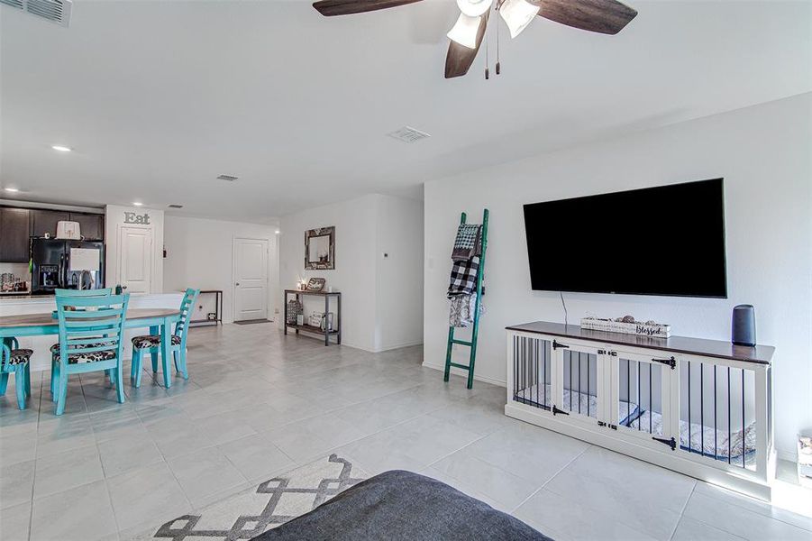 Living room featuring ceiling fan and light tile patterned flooring